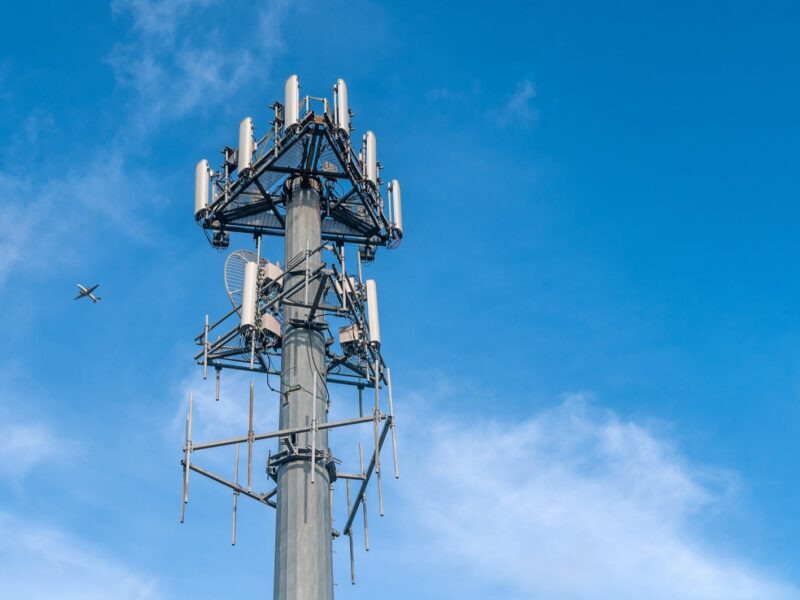 5G cell tower infrastructure against a clear blue sky